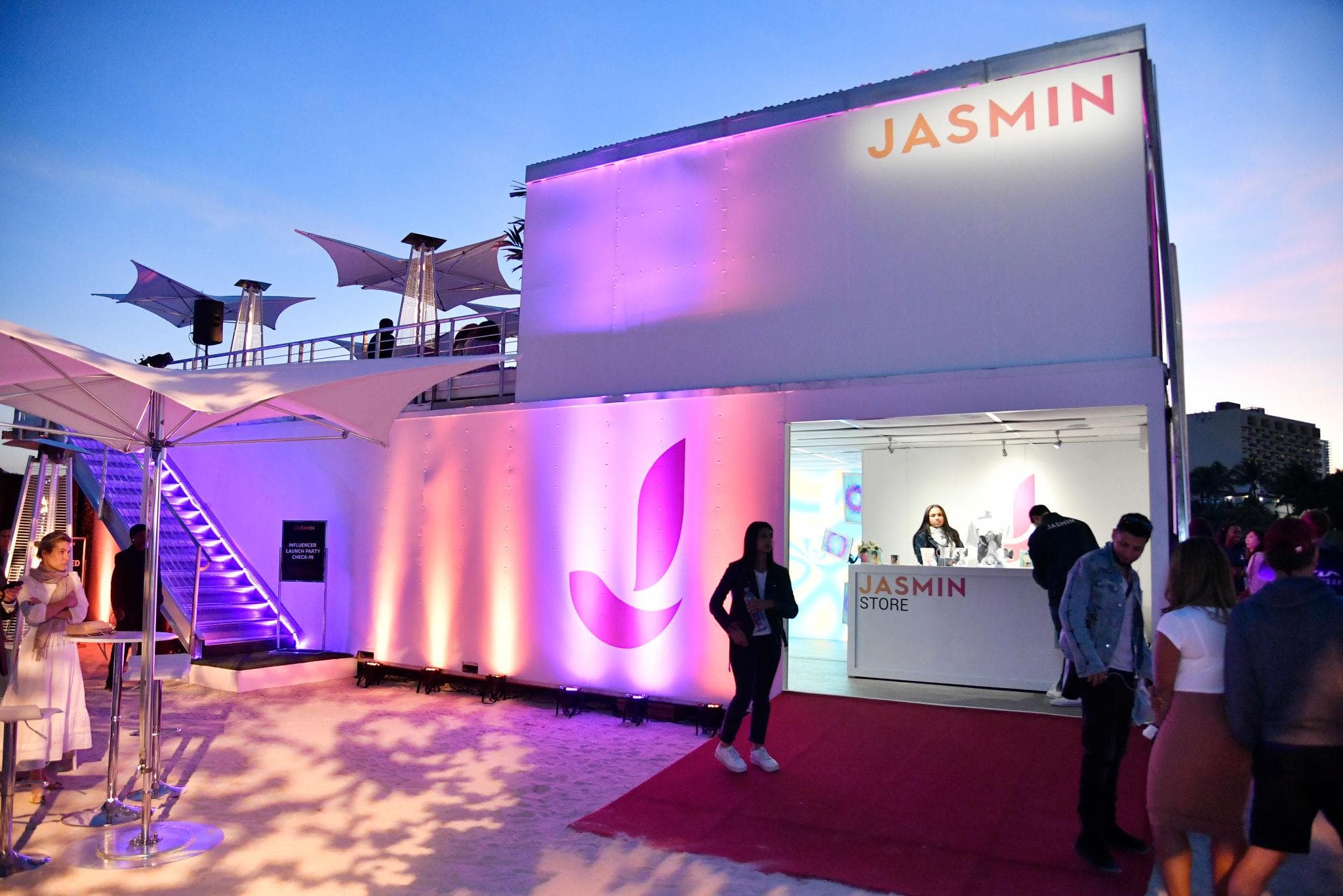 Luxury brand pop-up pavilion with full-height glass walls and clean architectural lines